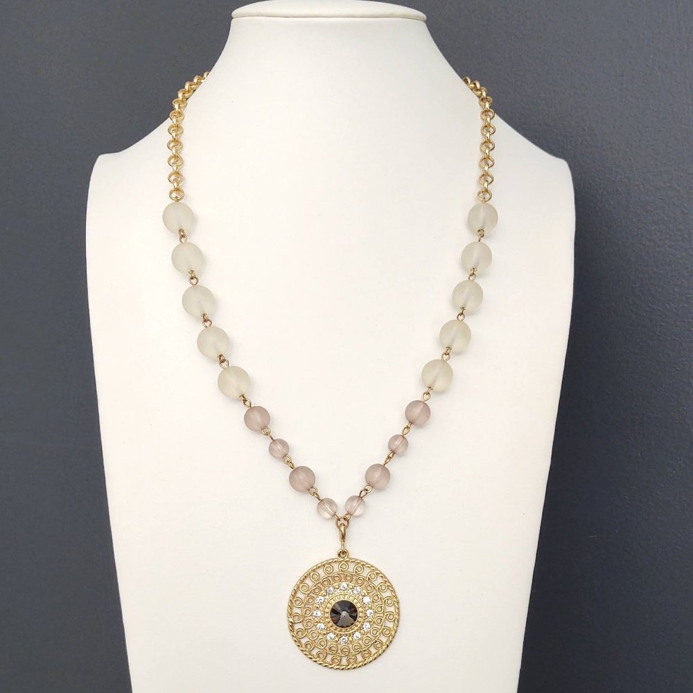 Gold pendant with center stone and cz's on gold chain with glass beads